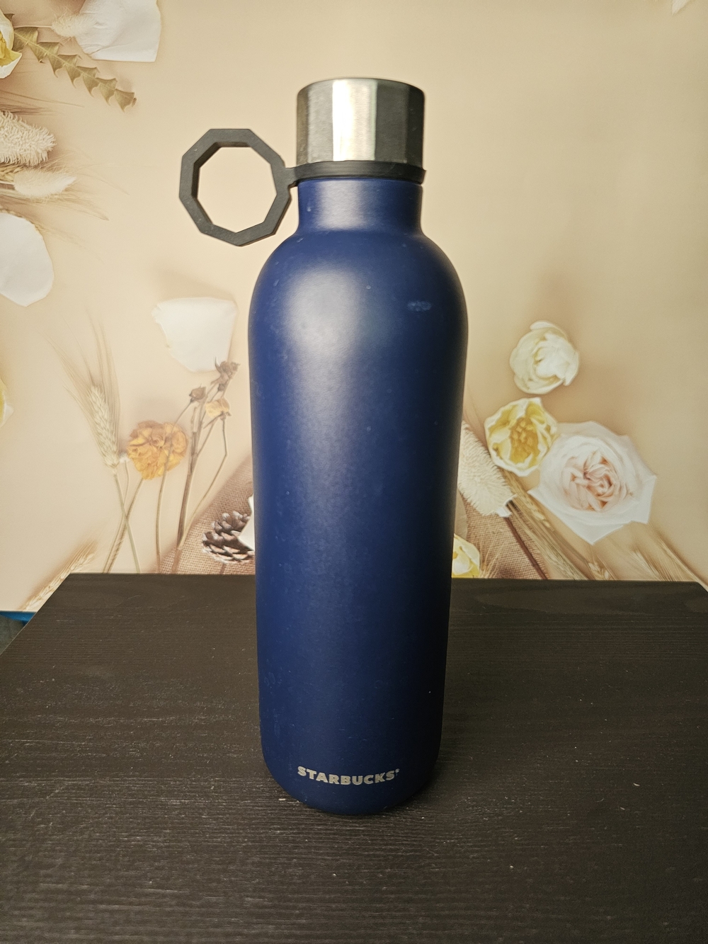 Stainless Steel Bottle on Floral Surface